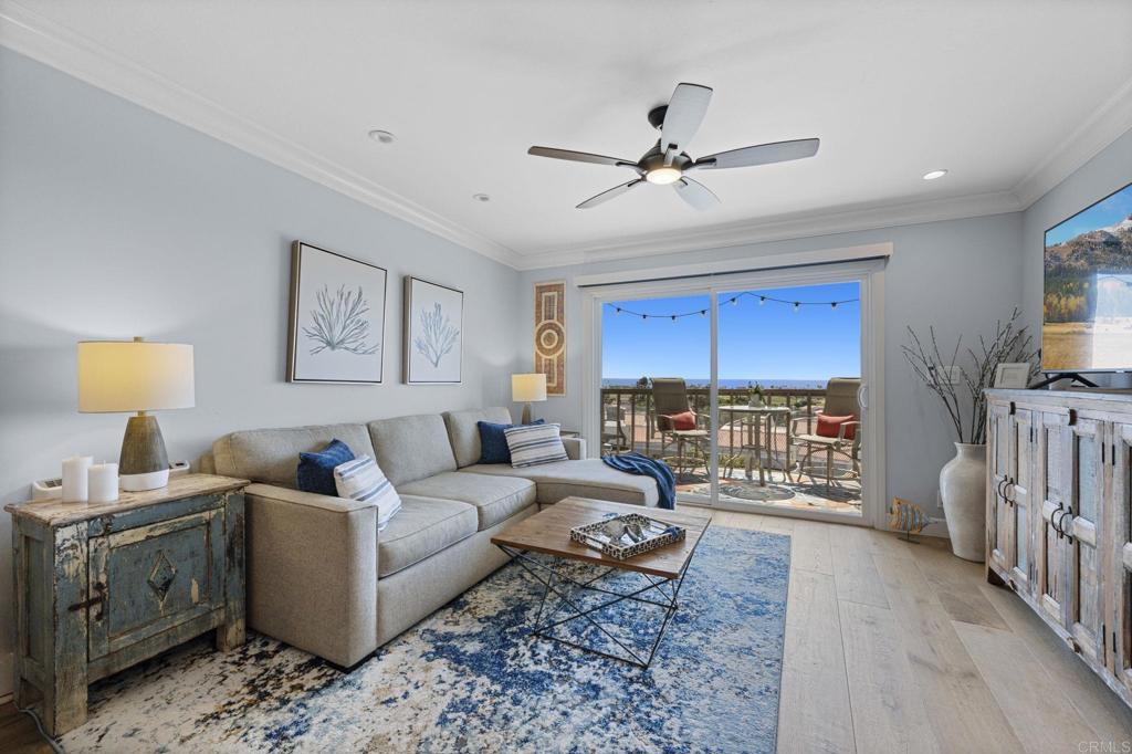 908 Caminito Madrigal, Unit D Carlsbad, CA 92011 - Photo 7 of 23 a living room with furniture and a flat screen tv