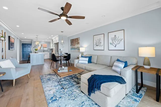 a living room with furniture and kitchen view
