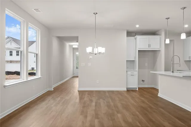 a view of a kitchen center island cabinets and wooden floor