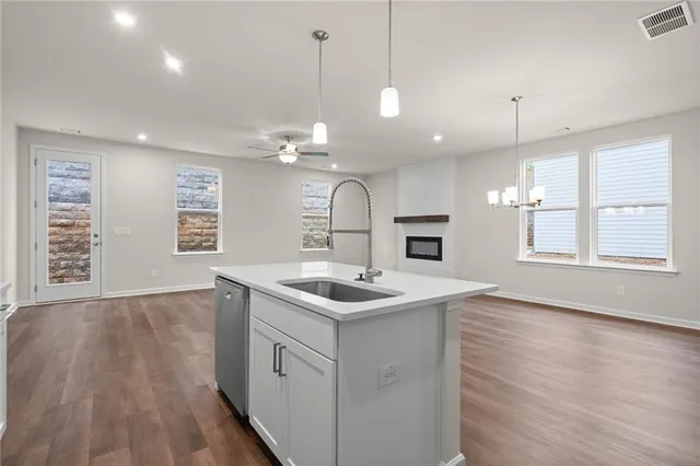a kitchen with a sink and chandelier
