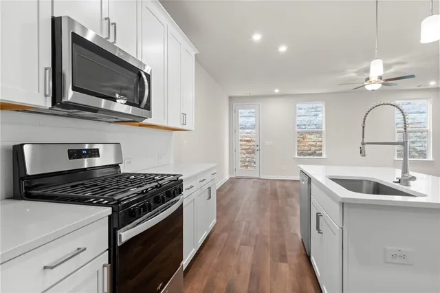 a kitchen that has a sink and a stove