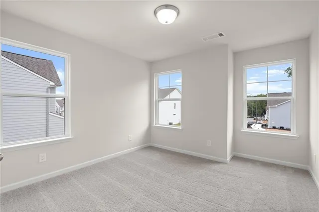 an empty room with windows and closet