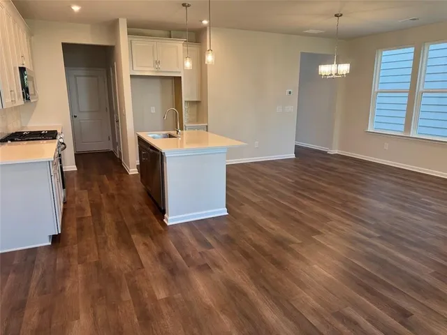 a large kitchen with cabinets wooden floor and a fireplace