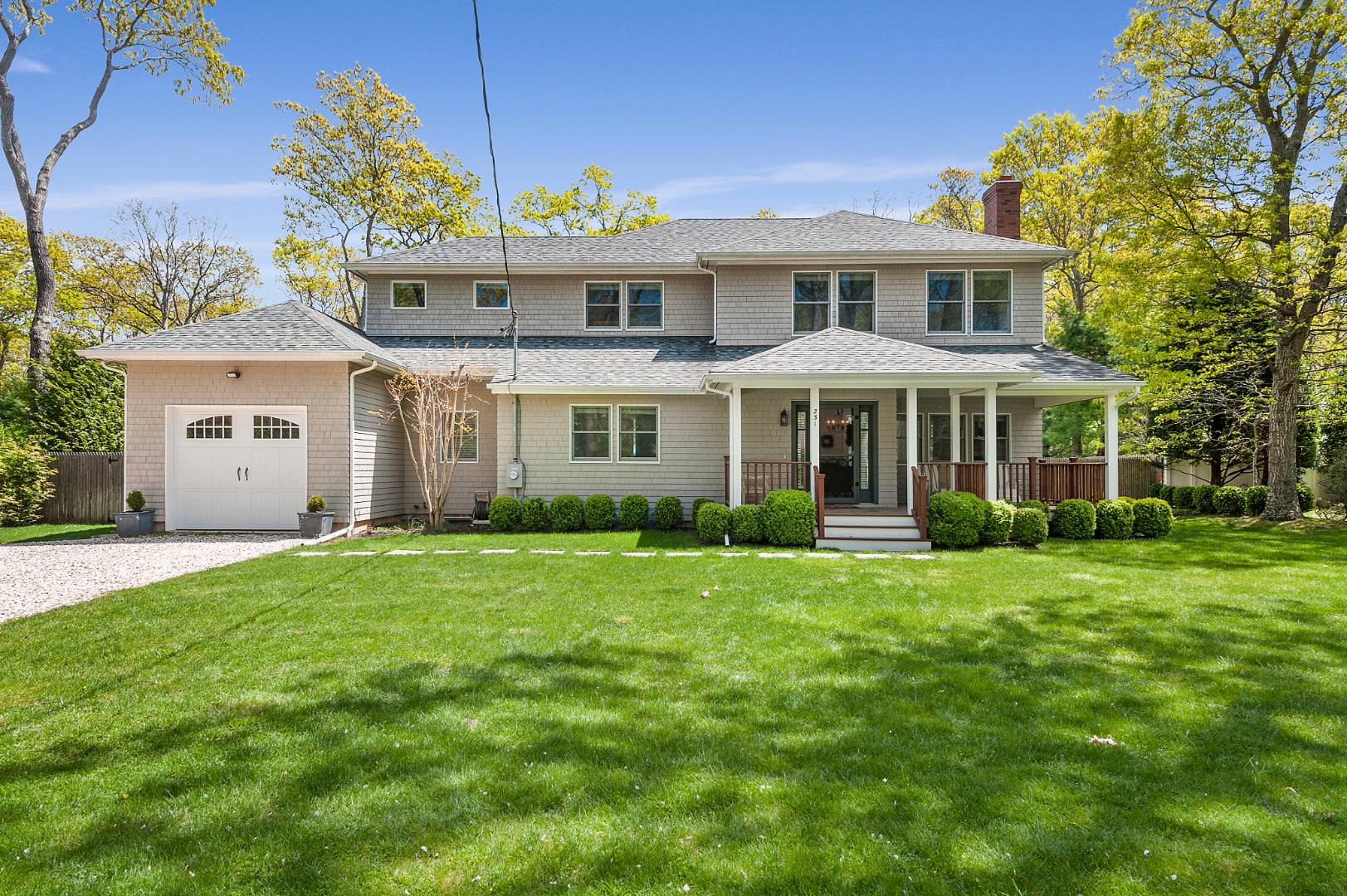 231 Norfolk Drive East Hampton, NY 11937 - Photo 2 of 17 a front view of a house with a garden