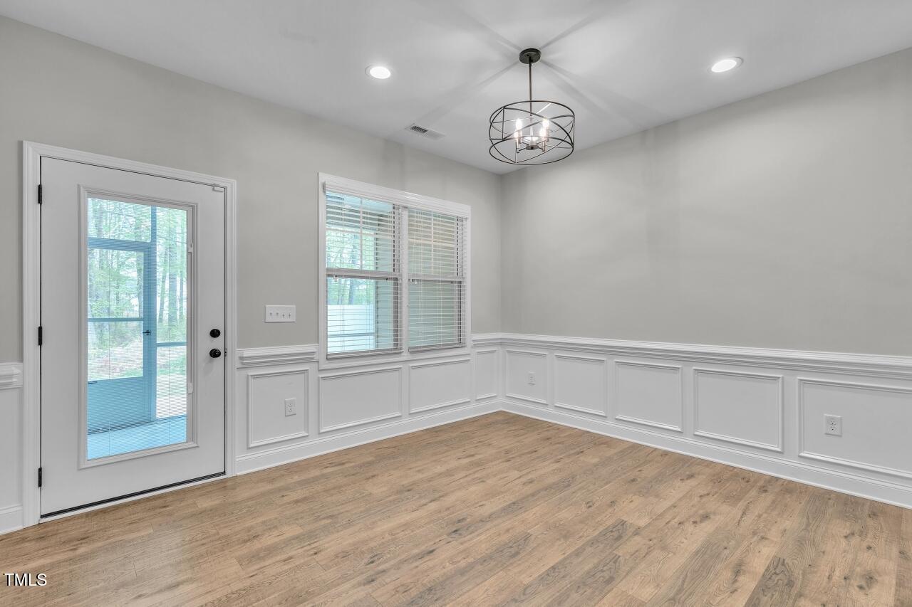 24 Highmeadow Lane Clayton, NC 27520 - Photo 14 of 37 an empty room with wooden floor and windows