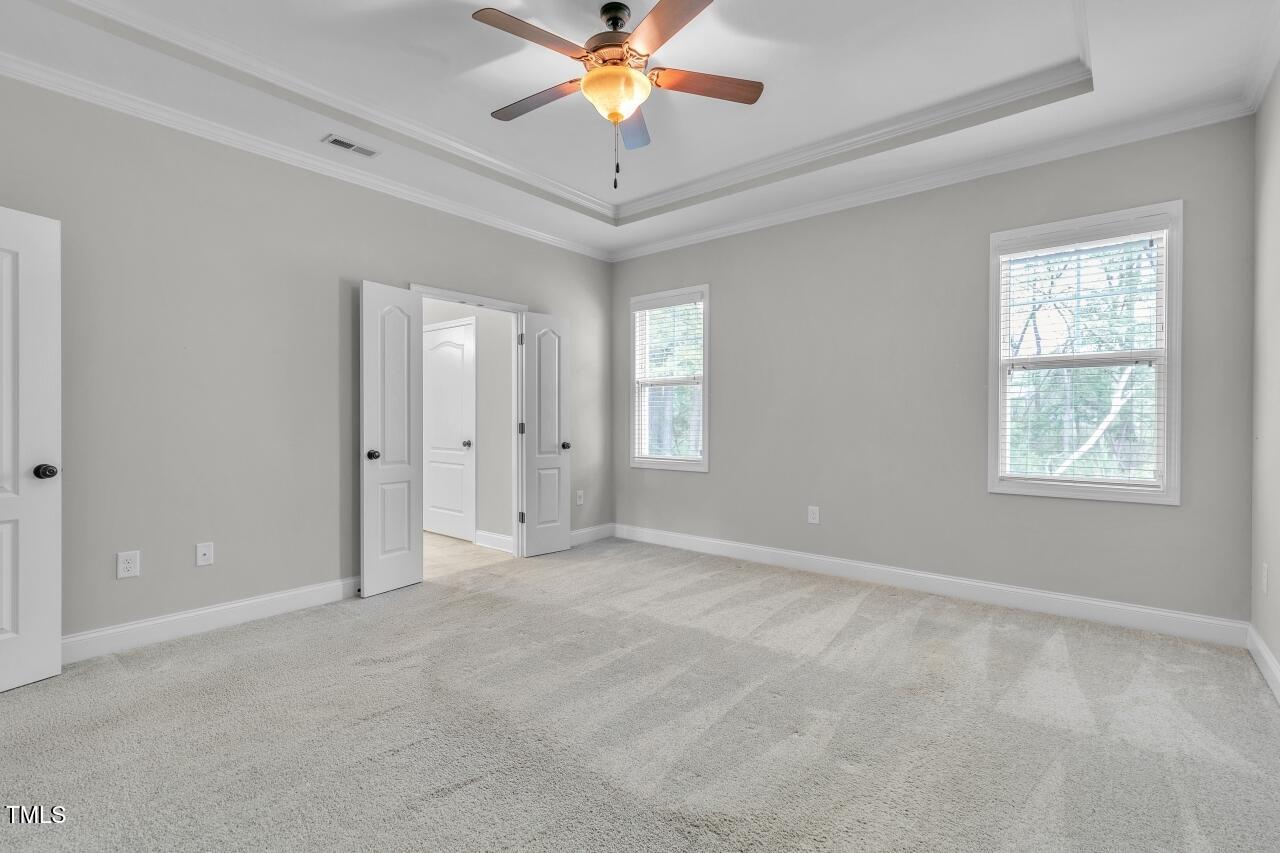 24 Highmeadow Lane Clayton, NC 27520 - Photo 20 of 37 an empty room with closet and chandelier fan