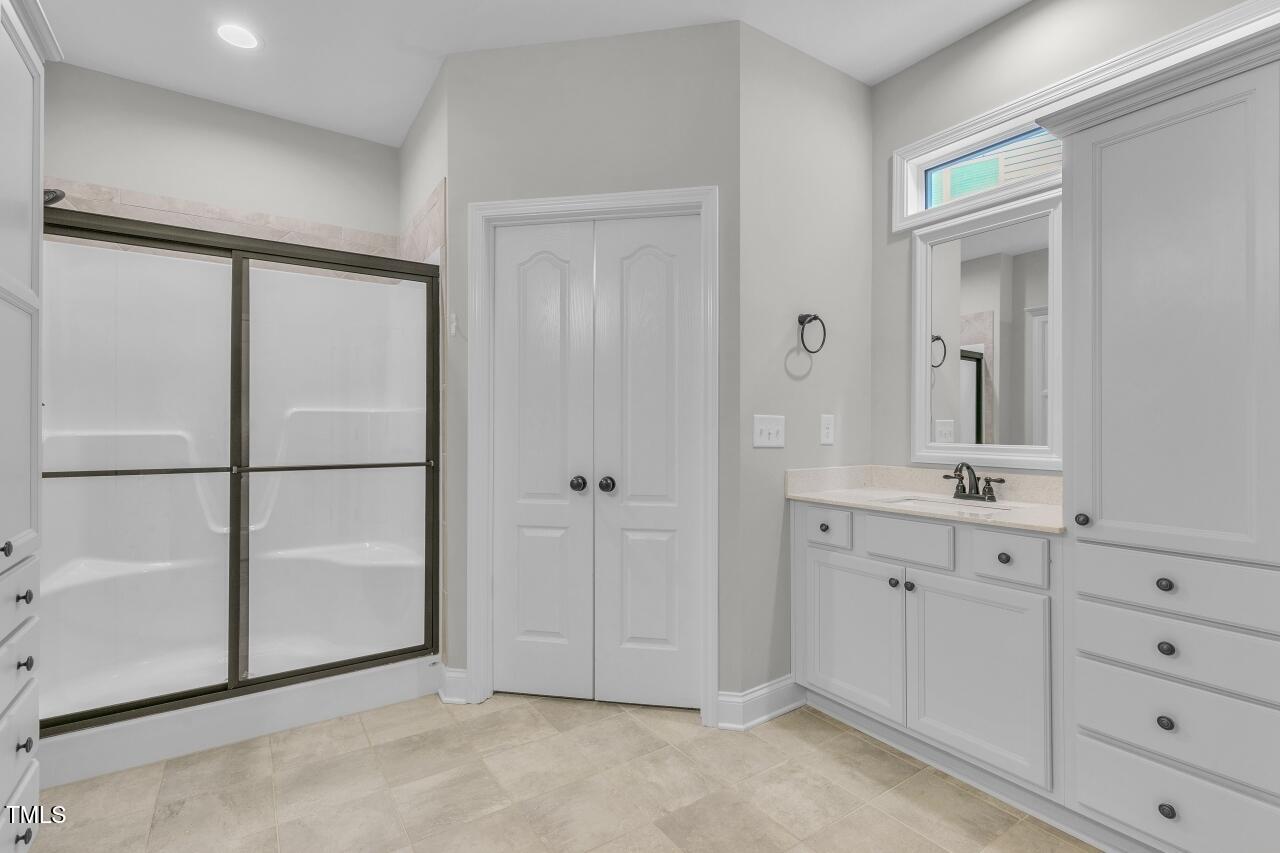 24 Highmeadow Lane Clayton, NC 27520 - Photo 23 of 37 a spacious bathroom with a double vanity sink a mirror and a bathtub