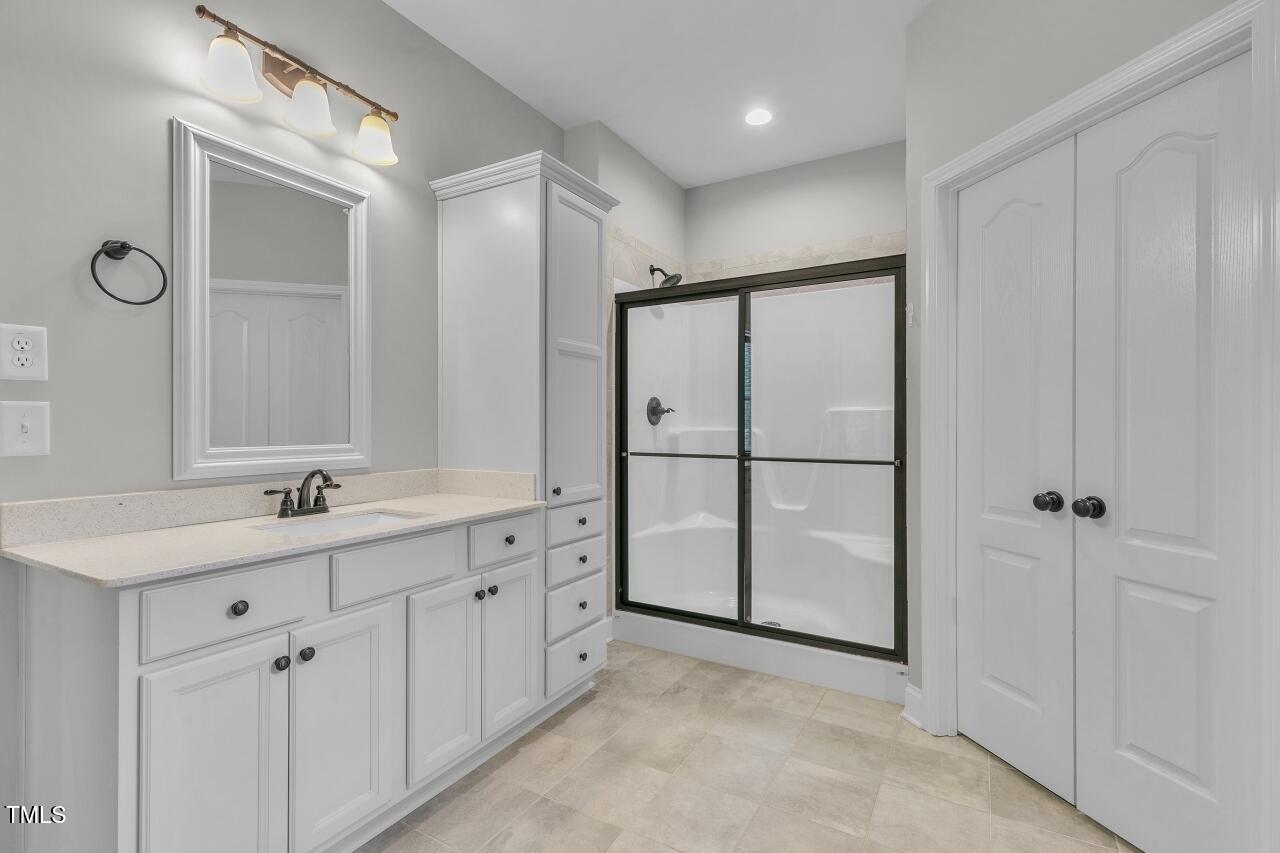 24 Highmeadow Lane Clayton, NC 27520 - Photo 24 of 37 a bathroom with a double vanity sink a and mirror