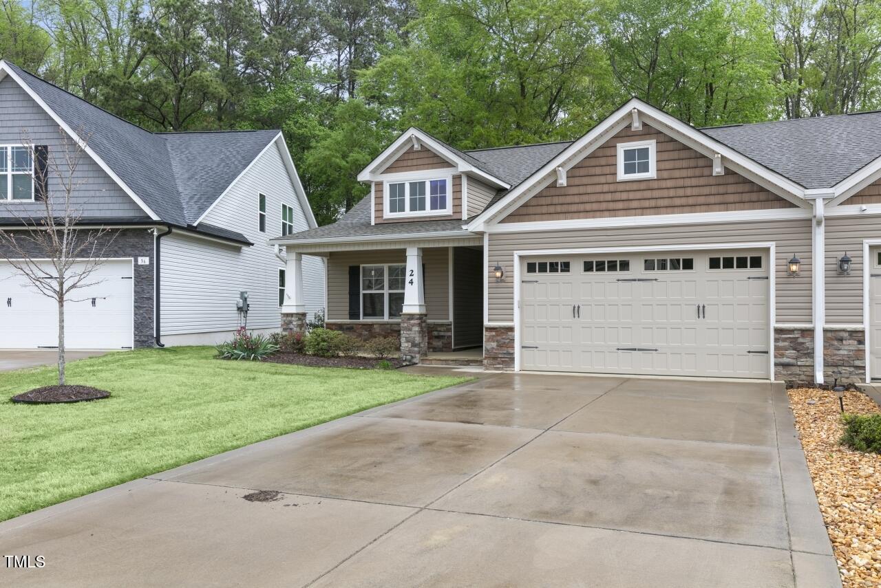 24 Highmeadow Lane Clayton, NC 27520 - Photo 3 of 37 a front view of a house with a yard and garage
