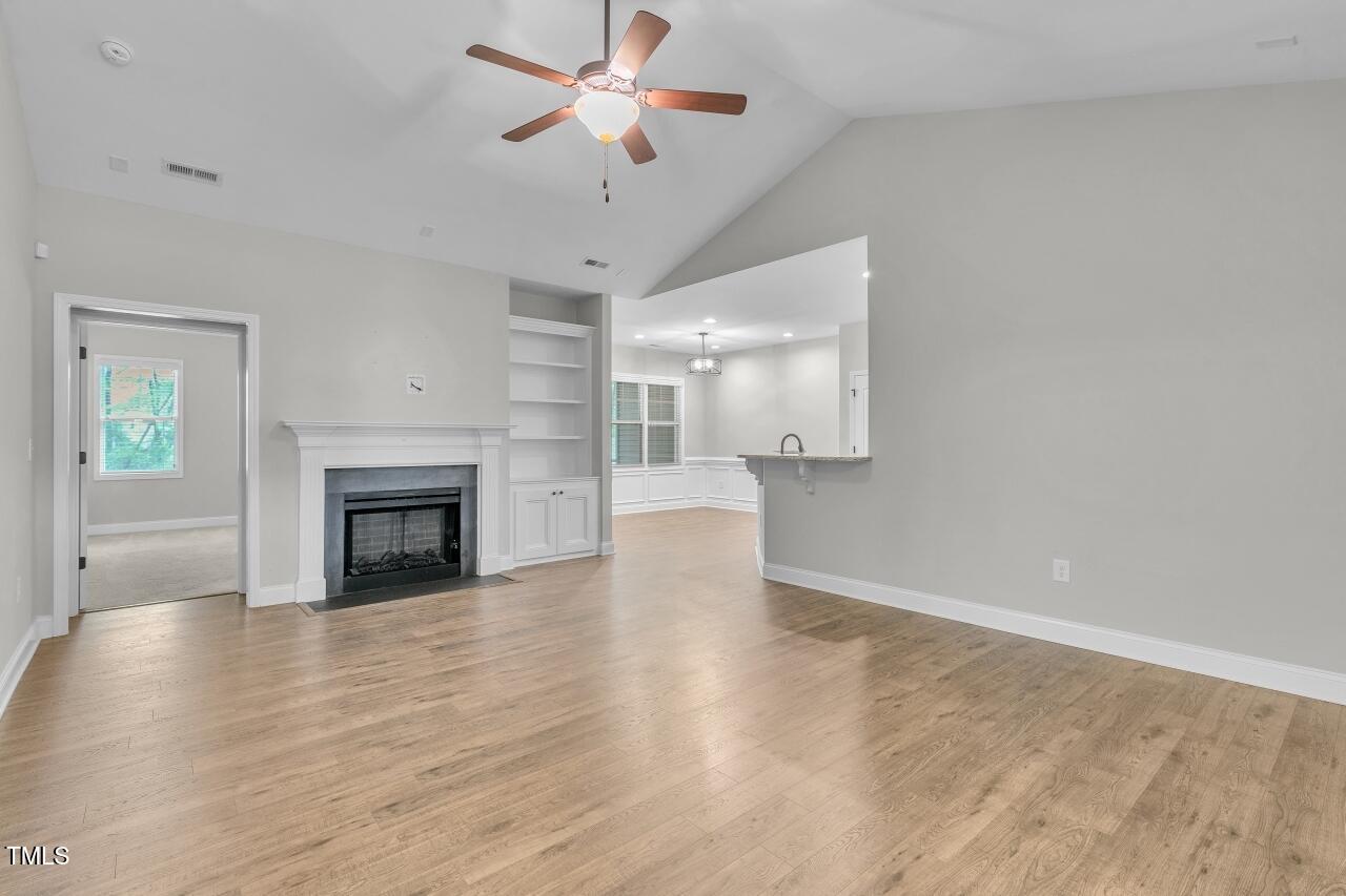 24 Highmeadow Lane Clayton, NC 27520 - Photo 7 of 37 a view of empty room with wooden floor and fireplace