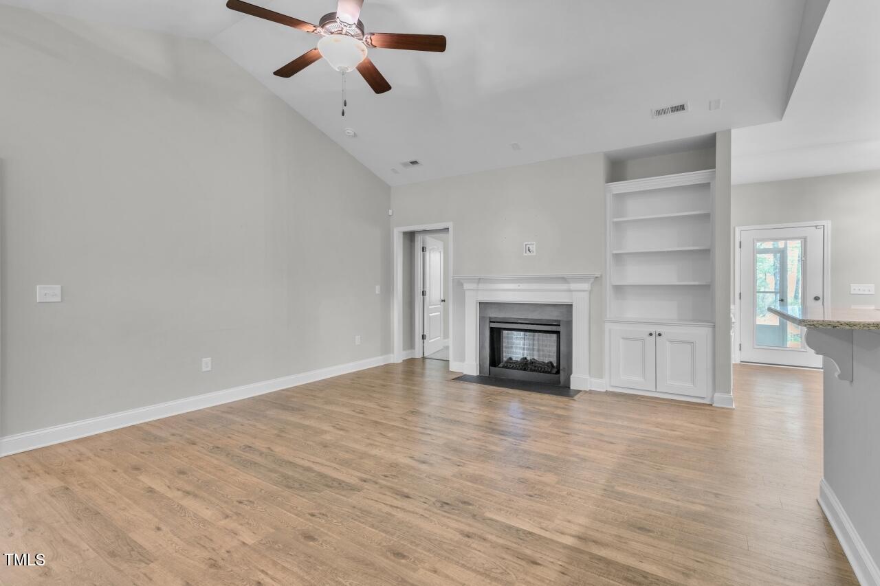 24 Highmeadow Lane Clayton, NC 27520 - Photo 8 of 37 a view of a livingroom with a fireplace and window