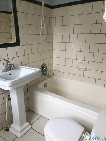 a bathroom with a sink a toilet and bathtub