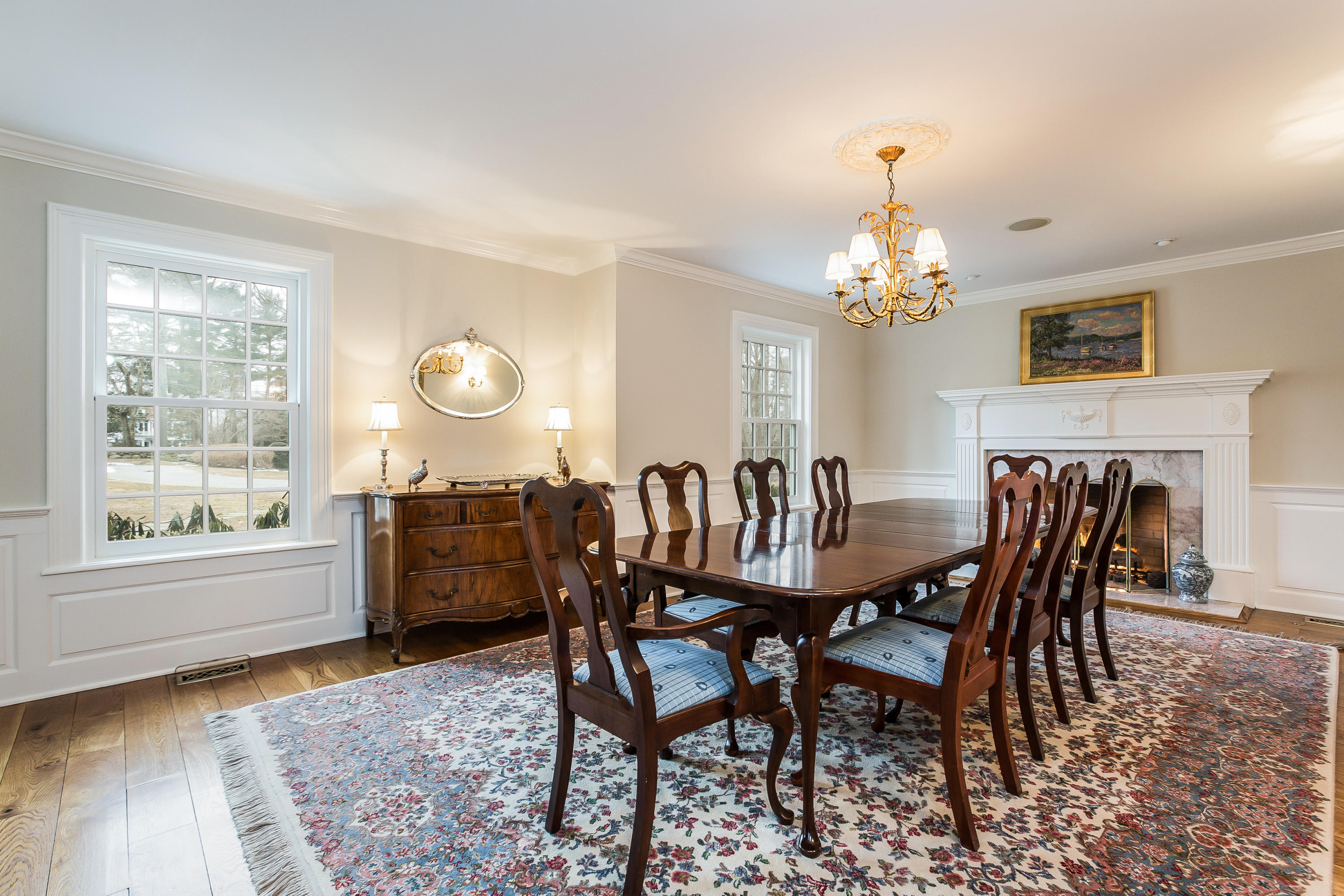 109 Rosebrook Road New Canaan, CT 06840 - Photo 12 of 47 a dining room with furniture a chandelier and wooden floor