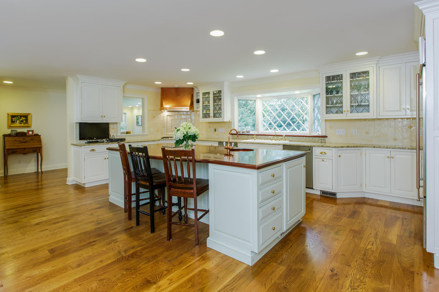 109 Rosebrook Road New Canaan, CT 06840 - Photo 14 of 47 a kitchen with a stove a sink a dining table and chairs