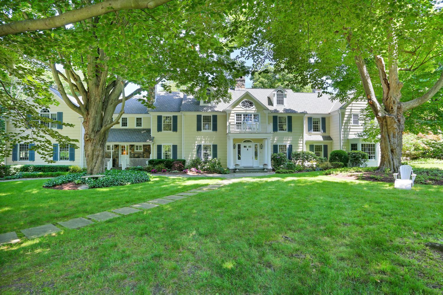 109 Rosebrook Road New Canaan, CT 06840 - Photo 2 of 47 a front view of a house with a yard
