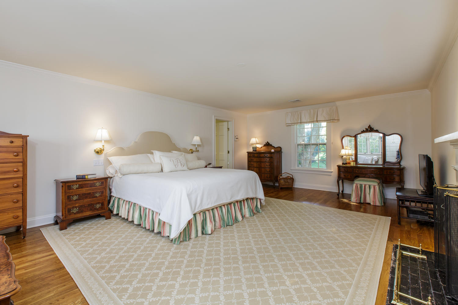 109 Rosebrook Road New Canaan, CT 06840 - Photo 22 of 47 a bedroom with a bed and wooden floor