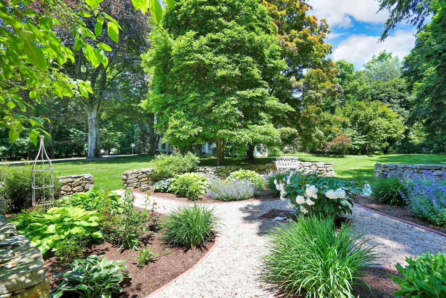 109 Rosebrook Road New Canaan, CT 06840 - Photo 3 of 47 a view of a garden with a bench