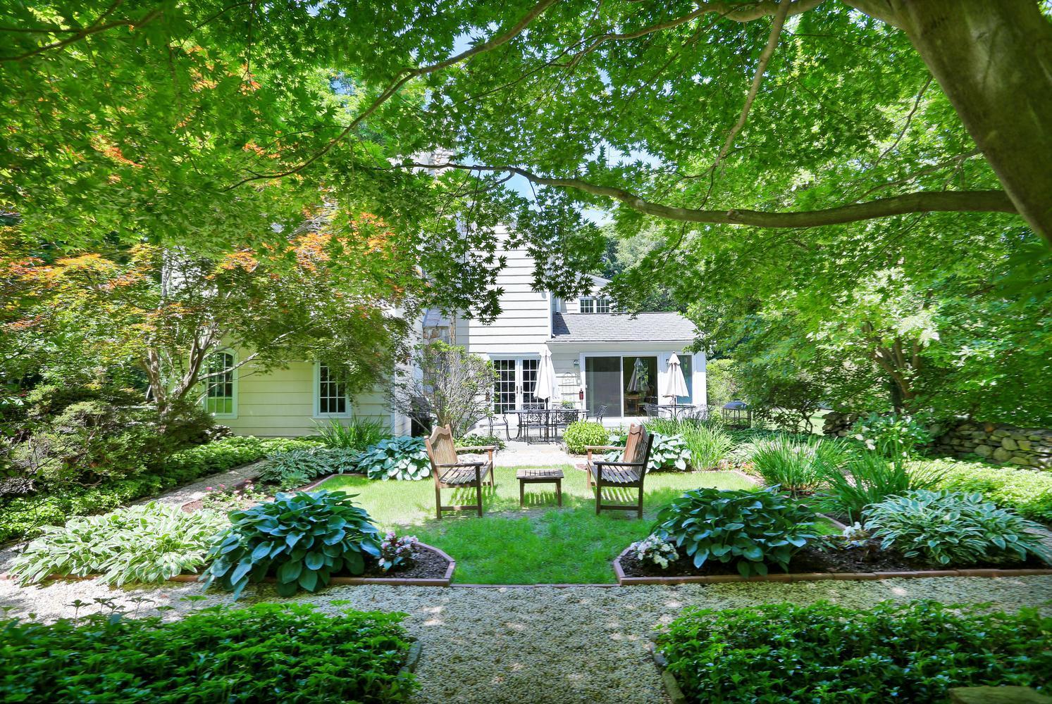 109 Rosebrook Road New Canaan, CT 06840 - Photo 35 of 47 a front view of a house with a garden