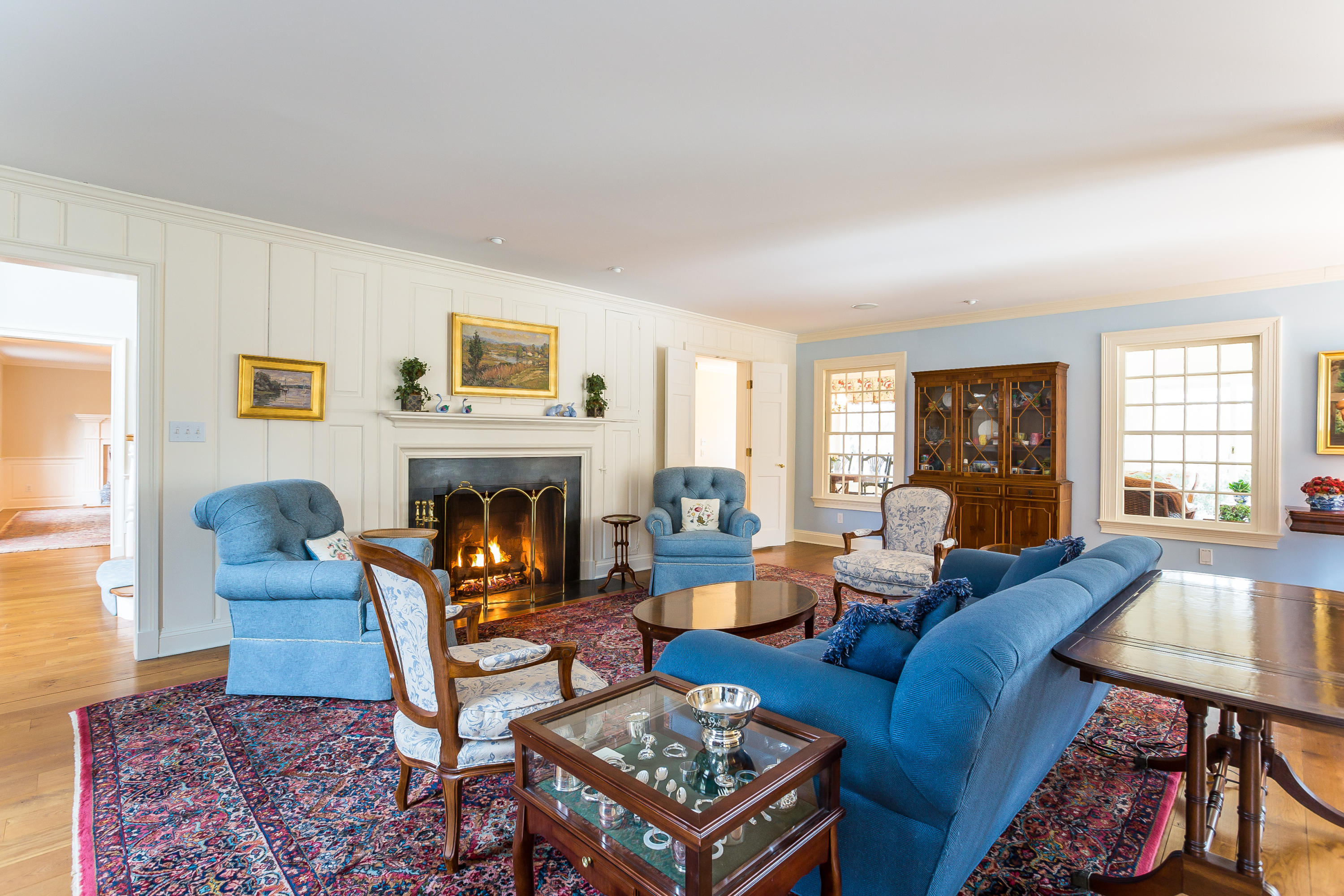 109 Rosebrook Road New Canaan, CT 06840 - Photo 9 of 47 a living room with furniture a rug a window and a fireplace