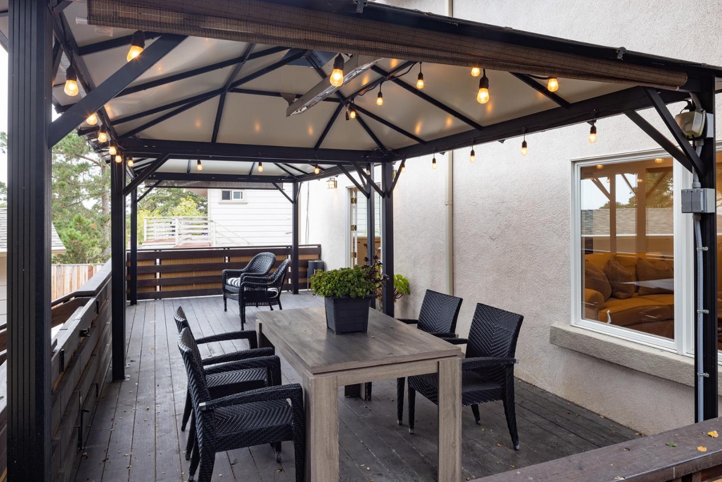 3288 Serra Avenue Carmel, CA 93923 - Photo 12 of 29 a view of a patio with table and chairs under an umbrella