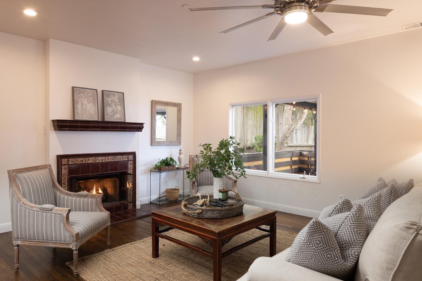 3288 Serra Avenue Carmel, CA 93923 - Photo 15 of 29 a living room with furniture a chandelier and a fireplace