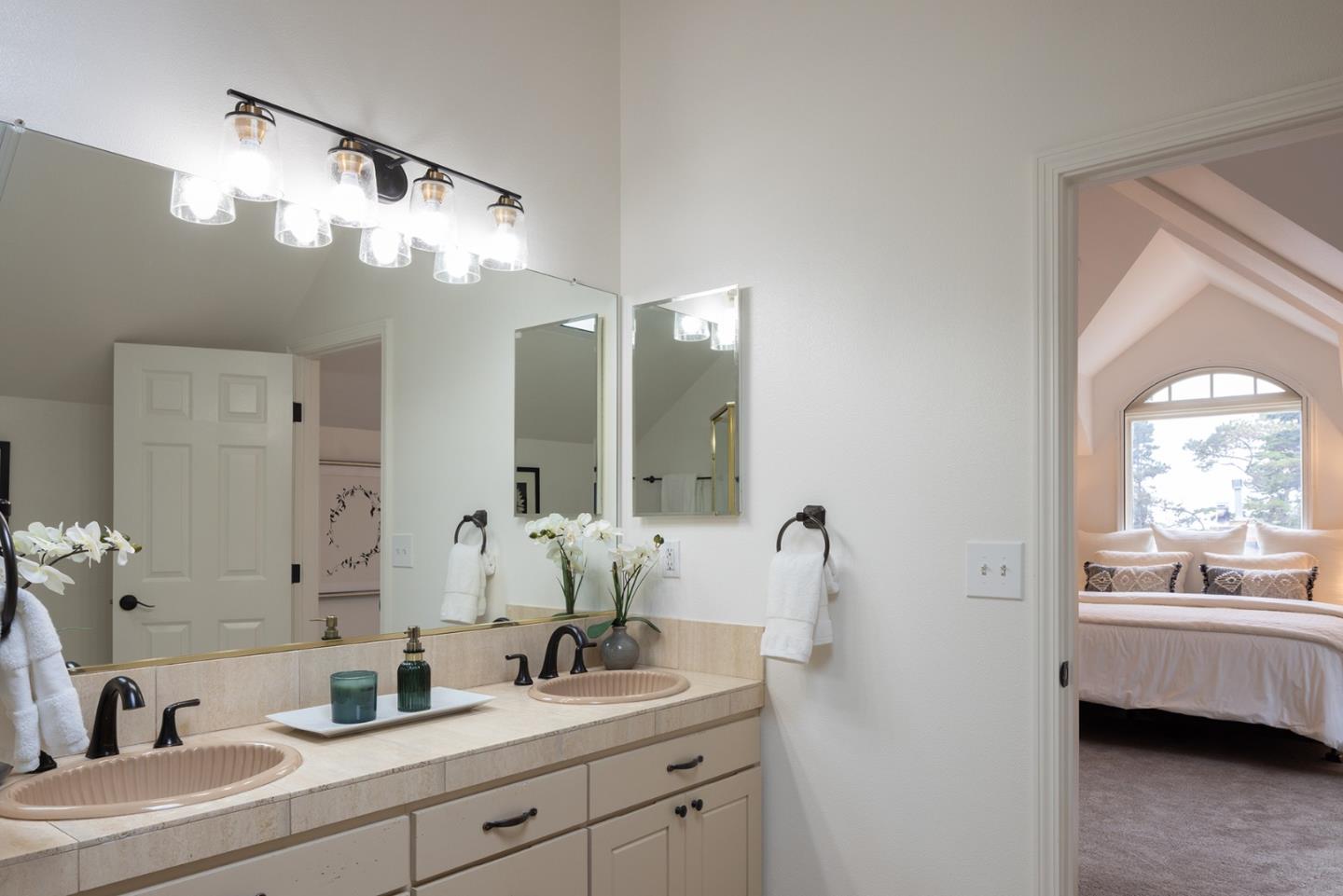 3288 Serra Avenue Carmel, CA 93923 - Photo 21 of 29 a bathroom with a sink a large mirror and a shower