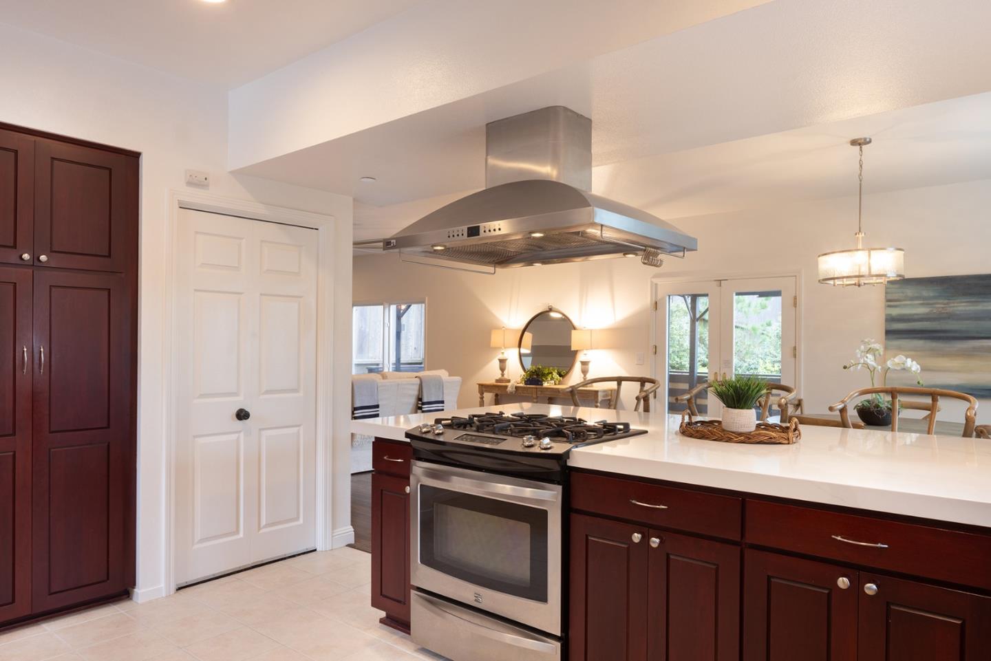 3288 Serra Avenue Carmel, CA 93923 - Photo 10 of 29 a kitchen with stainless steel appliances a stove a sink and a refrigerator