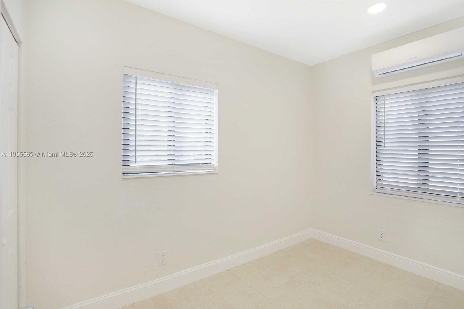 502 Northwest 7th Court, Unit 2 Hallandale Beach, FL 33009 - Photo 14 of 19 an empty room with a window