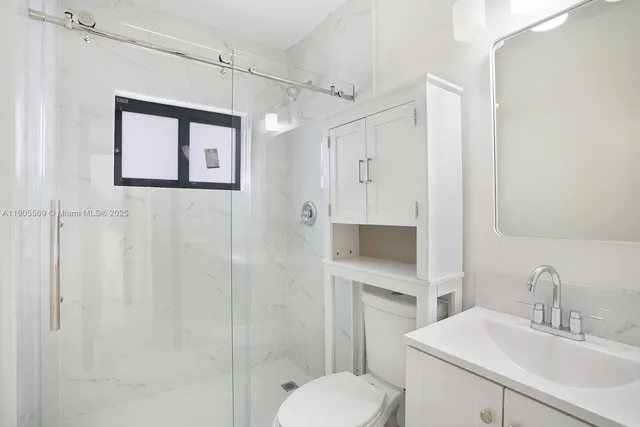 a bathroom with a toilet sink and shower