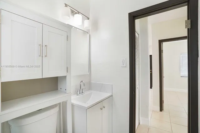 a kitchen with a sink and a mirror