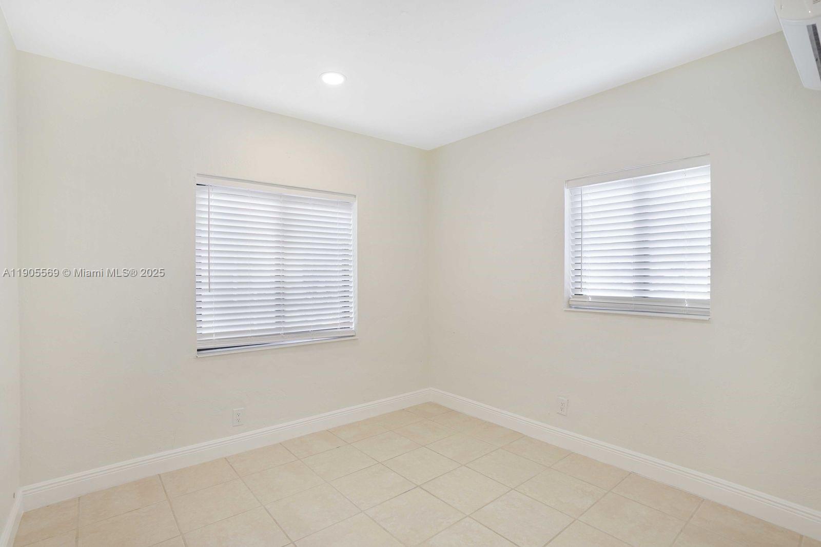502 Northwest 7th Court, Unit 2 Hallandale Beach, FL 33009 - Photo 7 of 19 an empty room with a window