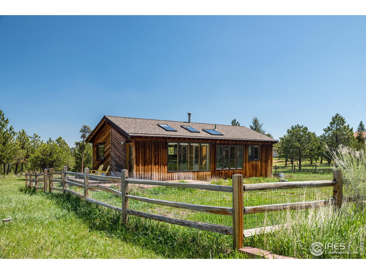 112 Deer Trail Road Boulder, CO 80302 - Photo 1 of 34 a front view of a house with a yard