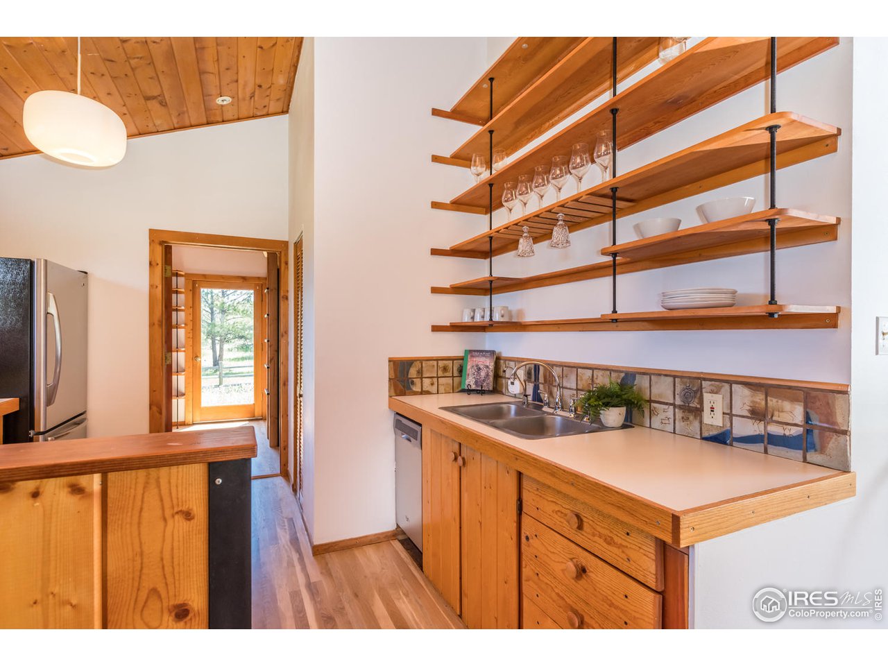 112 Deer Trail Road Boulder, CO 80302 - Photo 18 of 34 a kitchen with a refrigerator and a view of living room