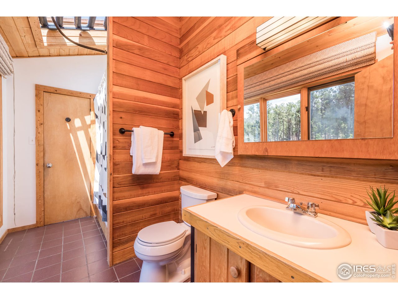 112 Deer Trail Road Boulder, CO 80302 - Photo 25 of 34 a bathroom with a sink a toilet and a mirror