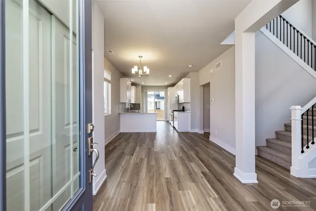 a view of a hallway view with wooden floor and staircase