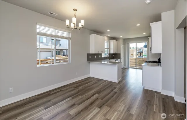 a view of a kitchen with microwave and cabinets