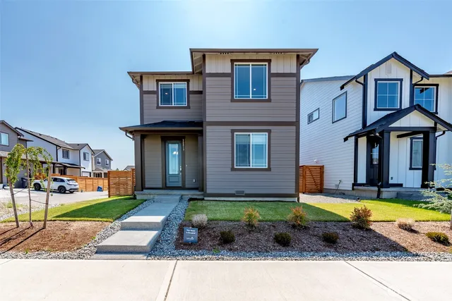 a view of a brick building with many windows and yard