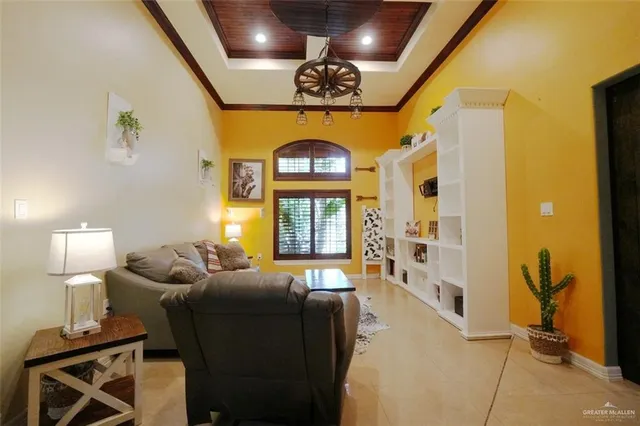 a living room with furniture a chandelier and a window