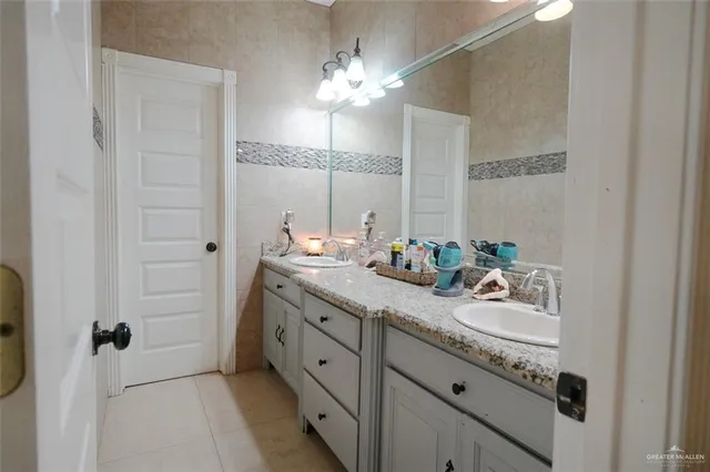 a bathroom with a double vanity sink and a mirror