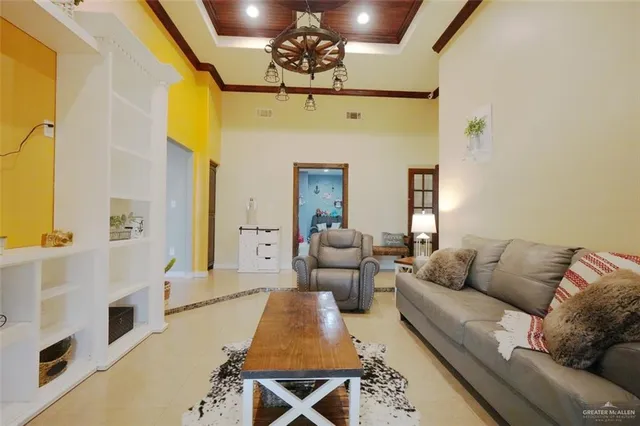 a living room with furniture and a chandelier