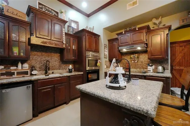 a kitchen with a sink a stove and cabinets