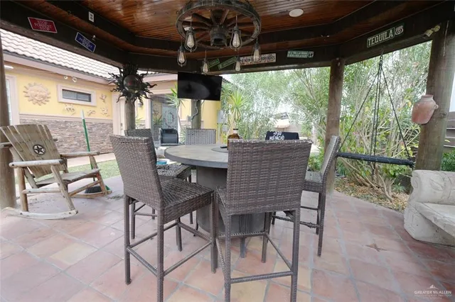 a view of a patio with a table chairs and a porch