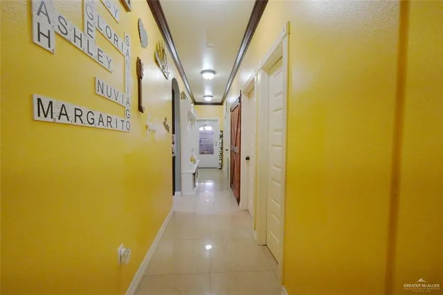 a view of a backyard with couches under an umbrella