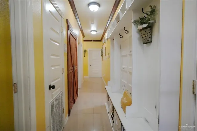 a view of a porch with chairs and floor to ceiling window