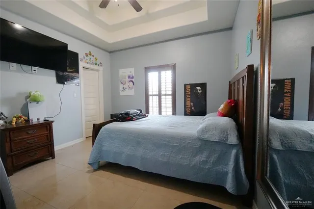 a bedroom with a bed and flat screen tv