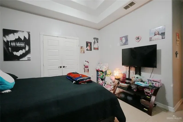 a bedroom with a bed and a flat screen tv