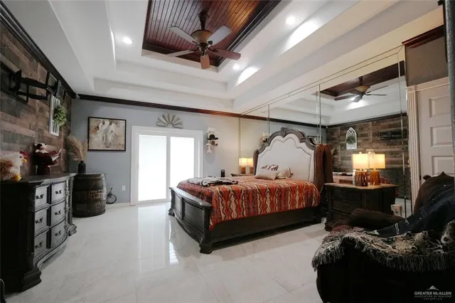 a spacious bedroom with a bed and wooden floor