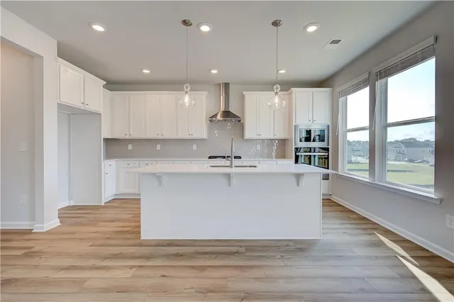 a view of kitchen with stainless steel appliances granite countertop a sink a stove and a refrigerator