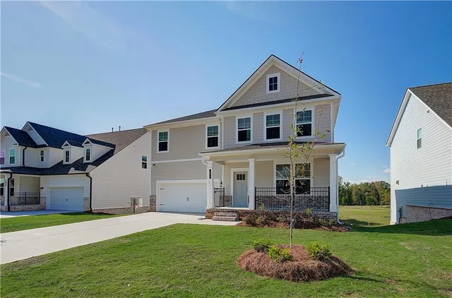 a front view of a house with a yard and porch