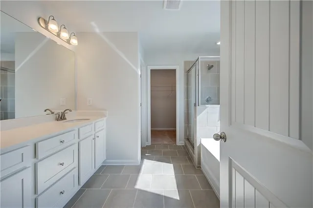 a bathroom with a double vanity sink and a mirror